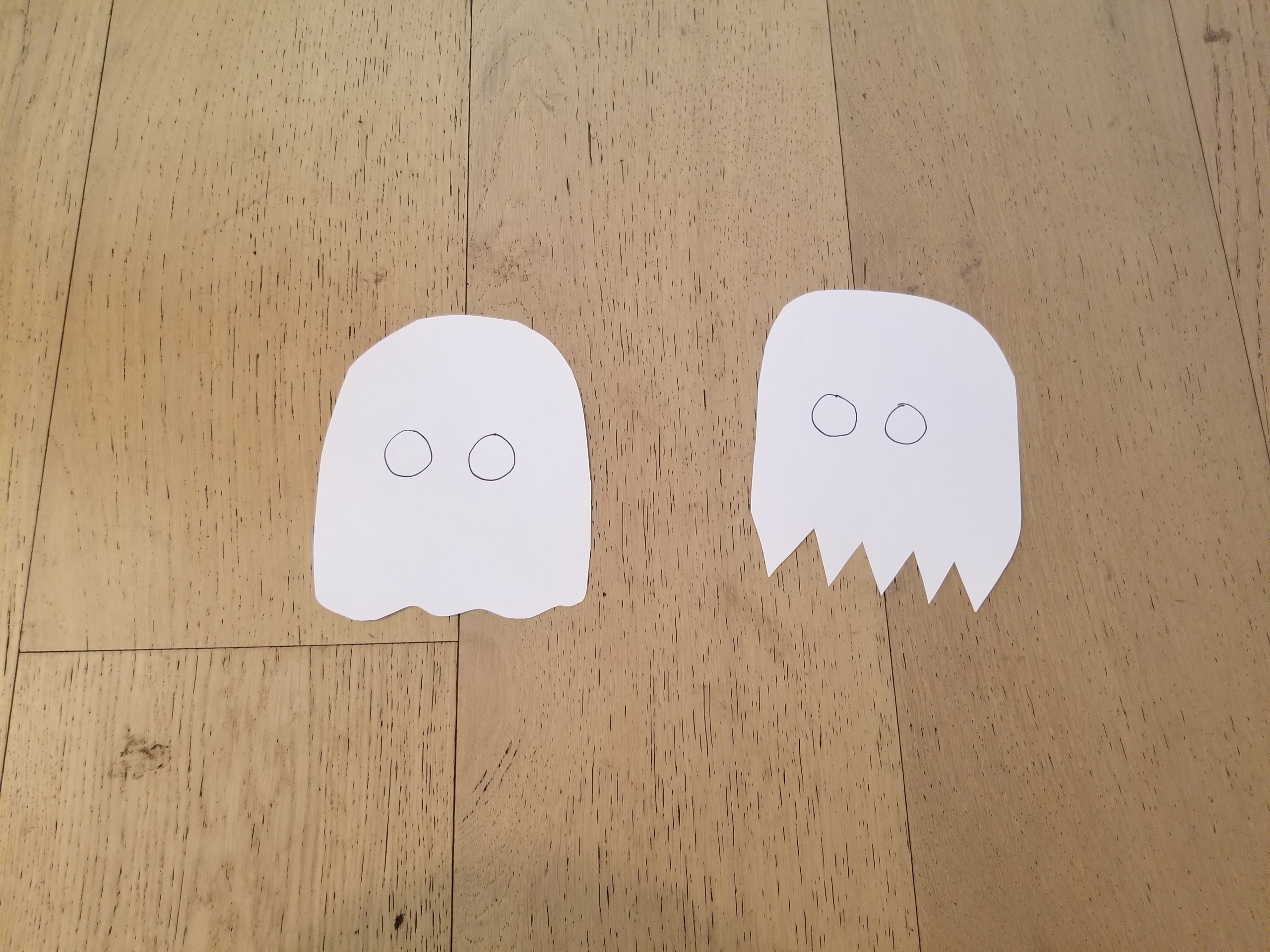 Paper ghosts with 'OO' drawn in the middle of each
