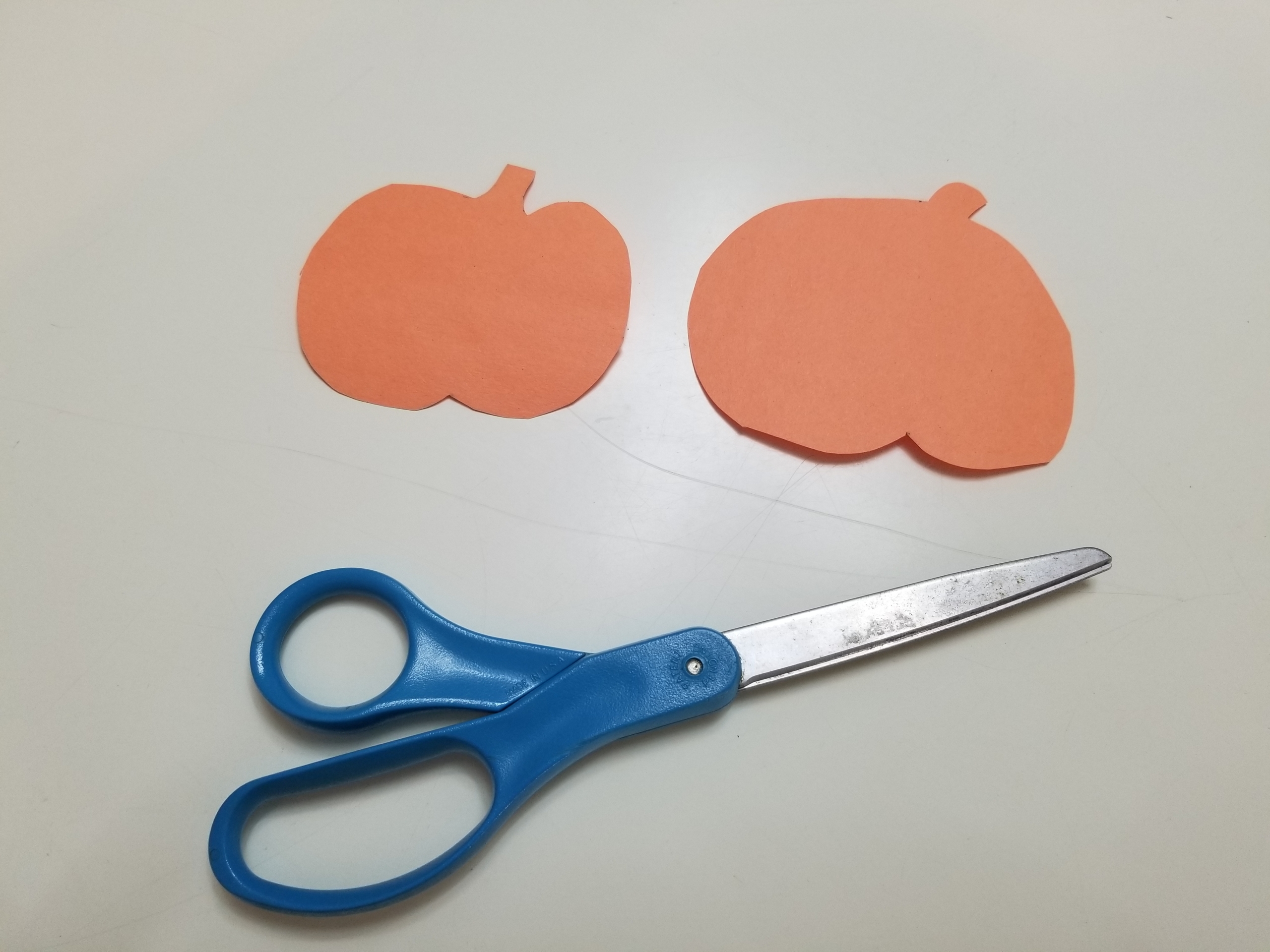 Two orange pumpkins cut out of paper