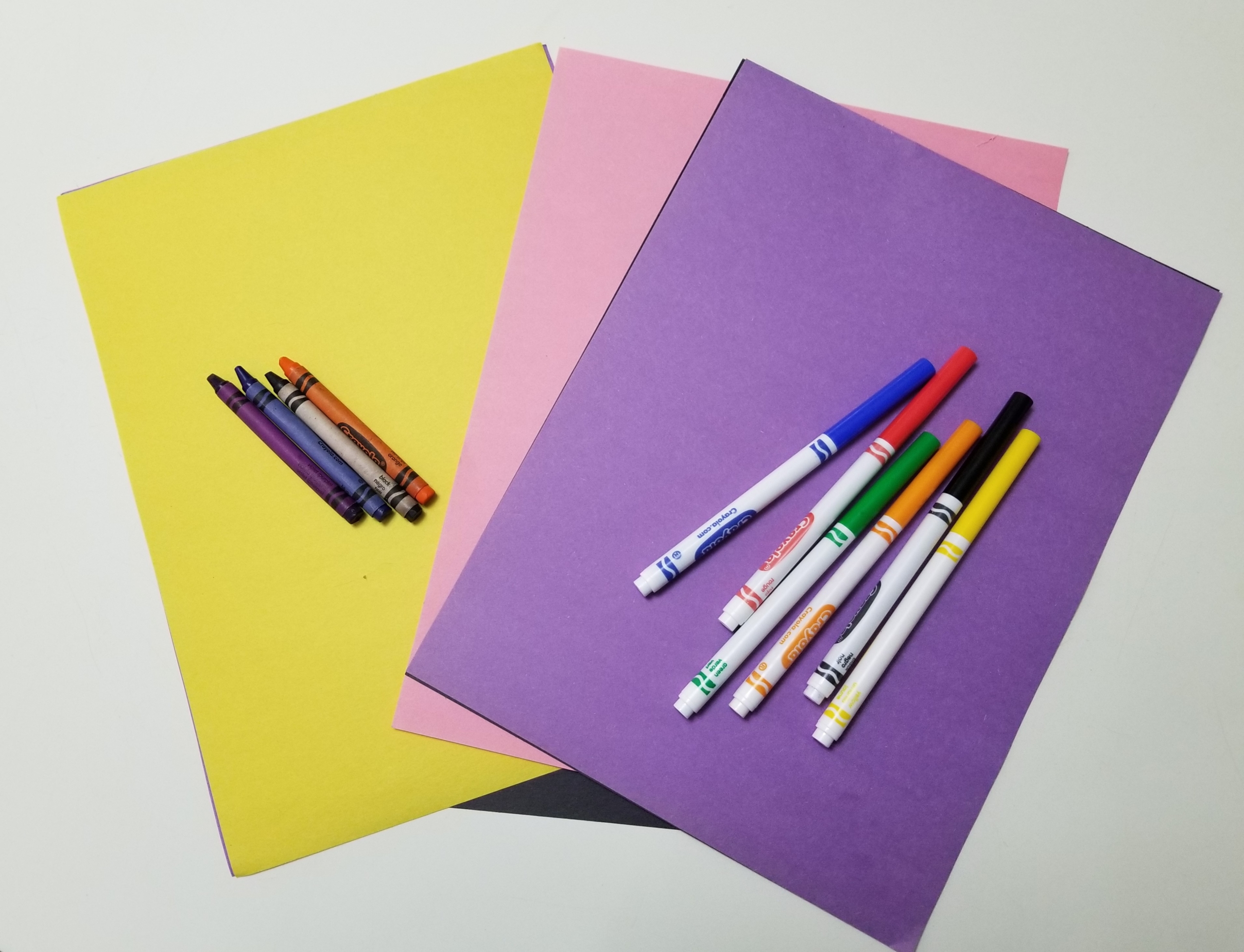 sheets of colored paper with colored markers