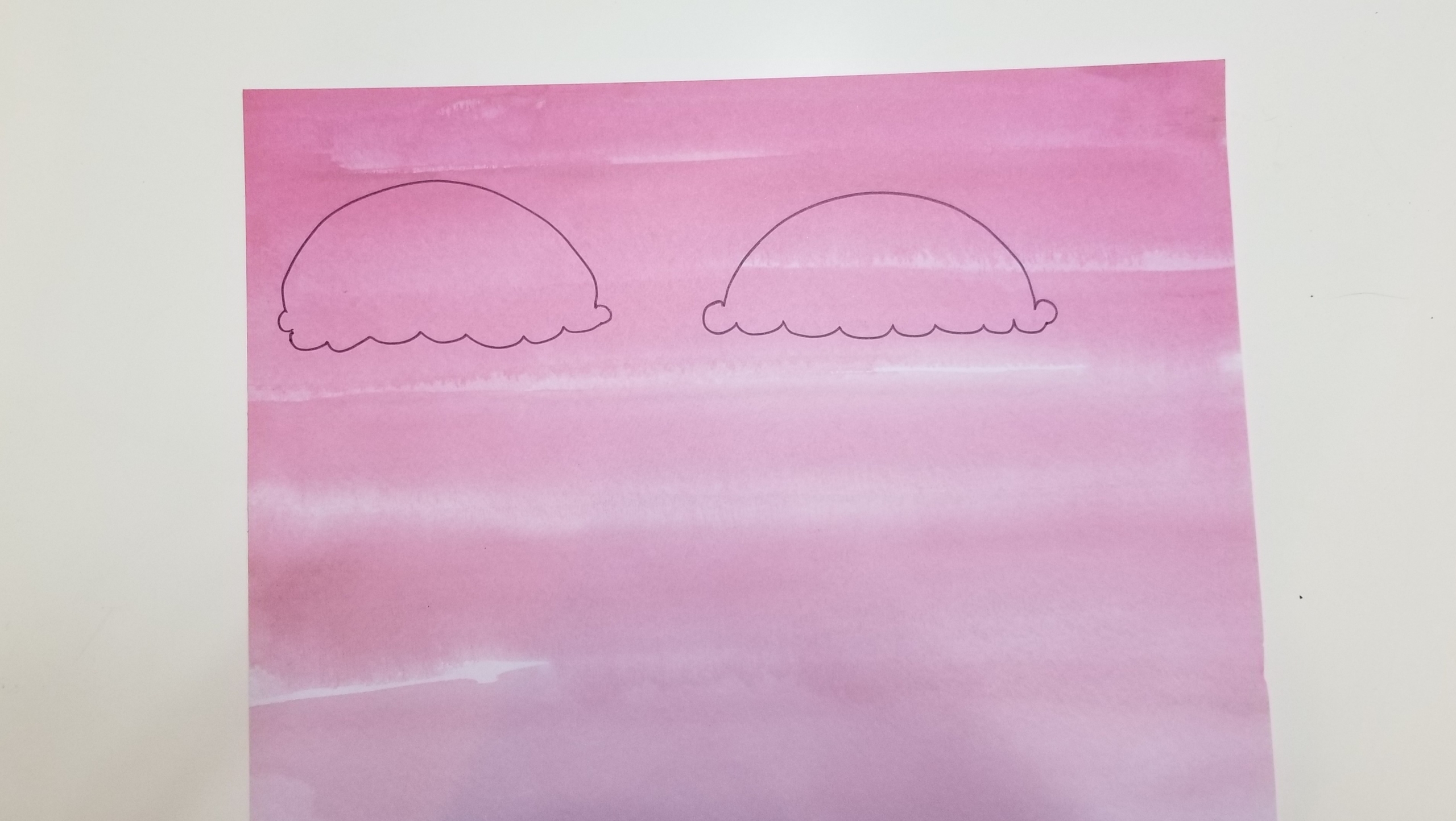 Two ice cream scoops drawn on pink paper