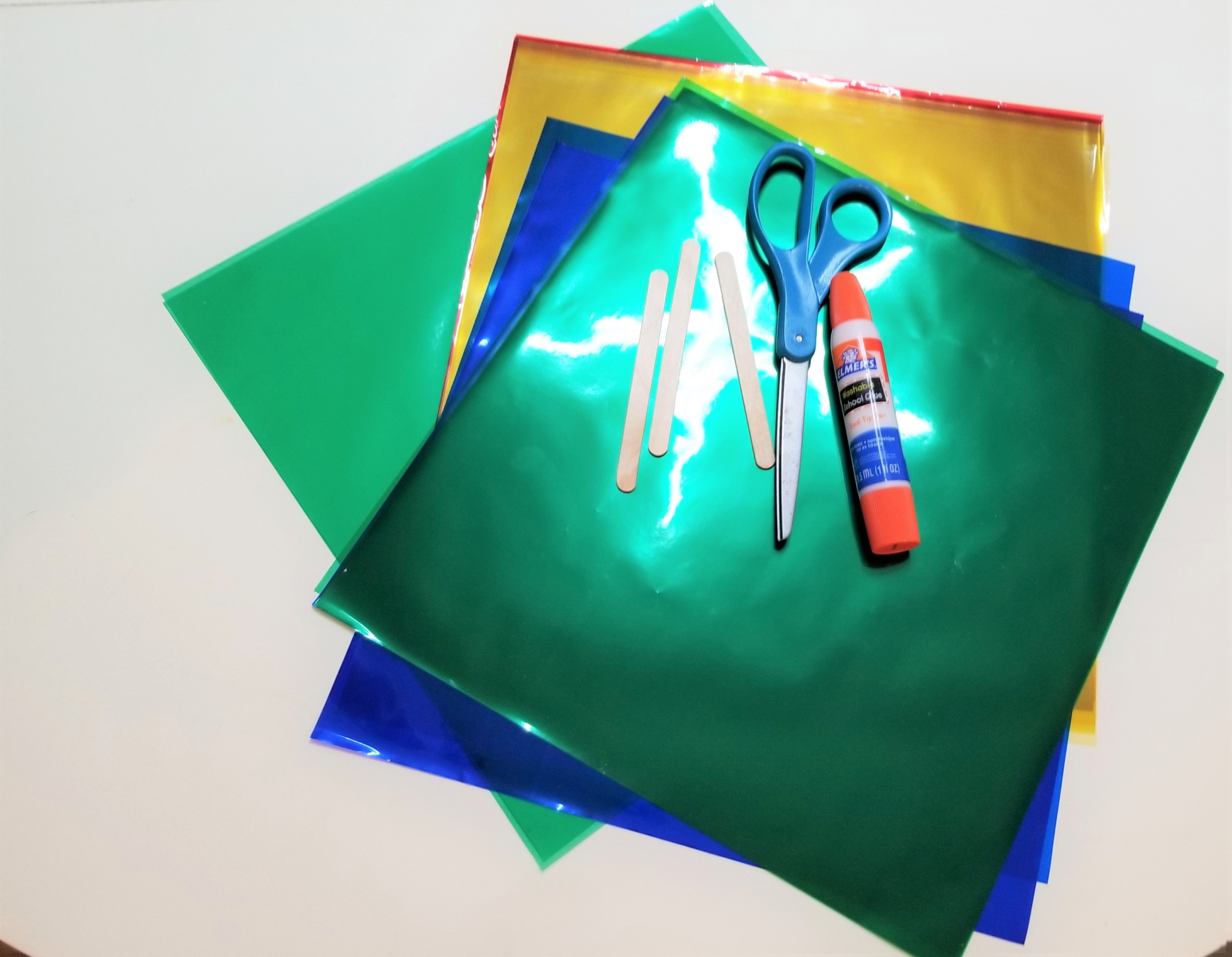 Plastic transparent folders, scissors, glue stick, craft sticks