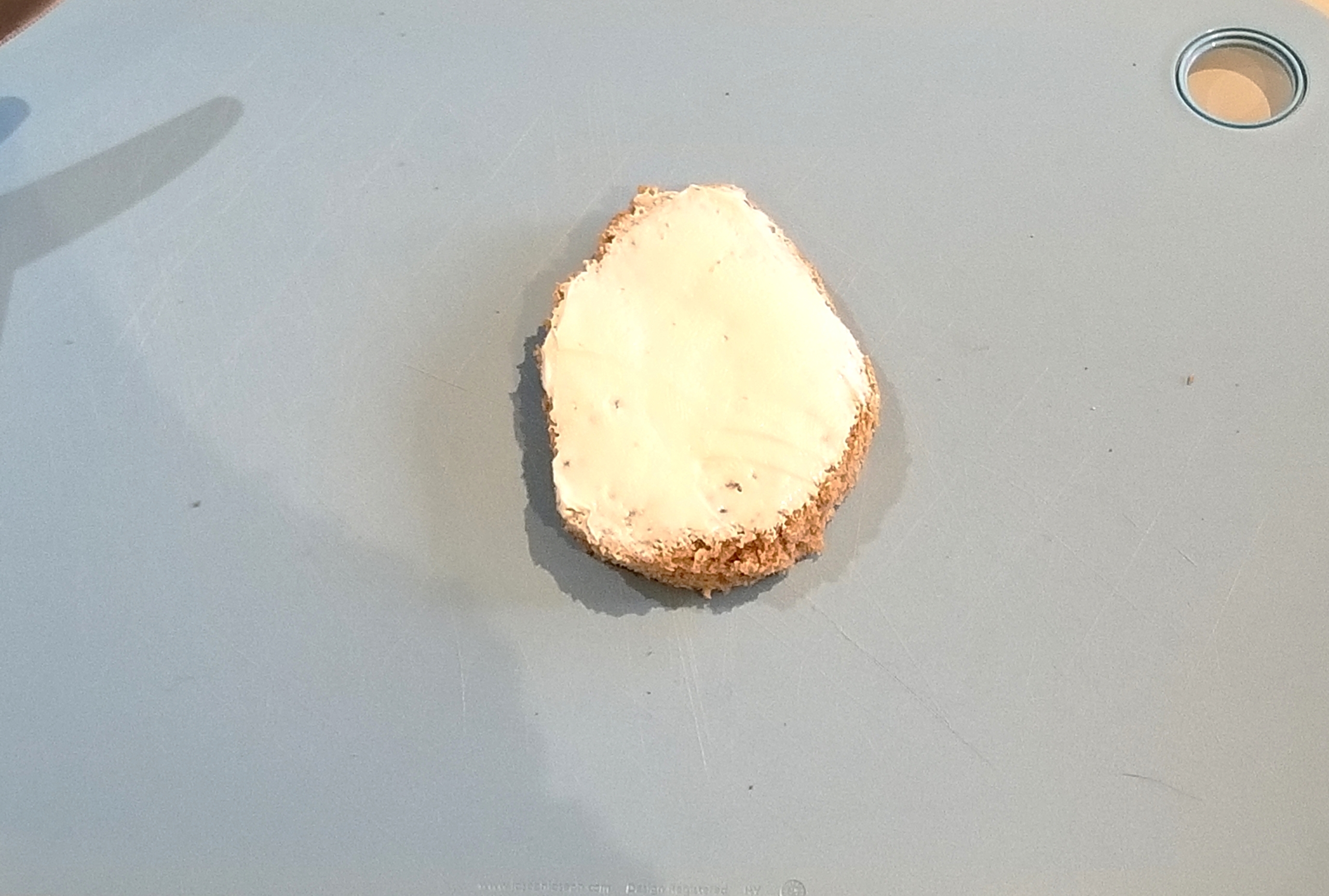 Easy Easter recipe step two - cream cheese spread onto piece of bread