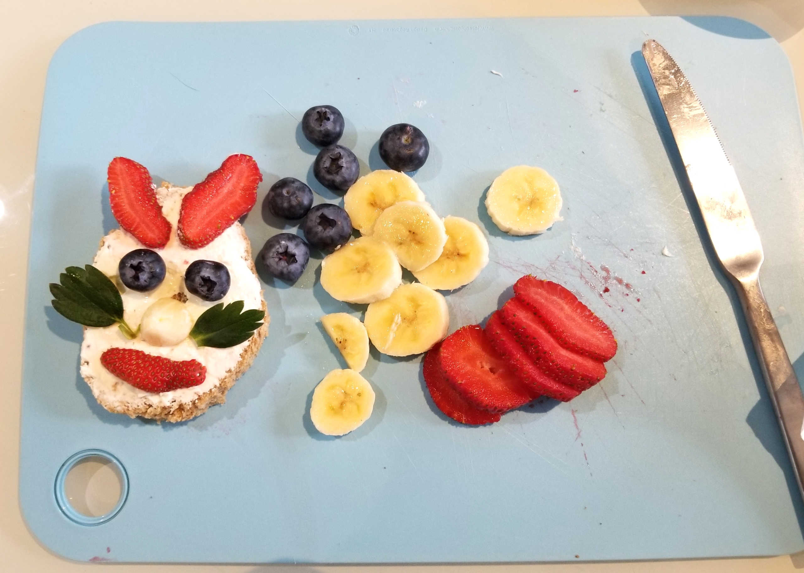 Easy Easter recipe step five - fruit arranged on bread with cream cheese in shape of bunny face