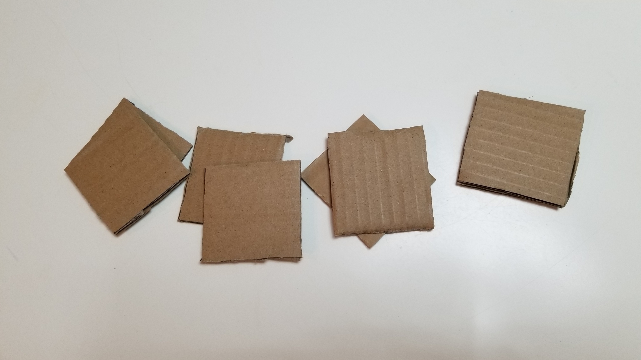 pieces of cardboard cut into squares